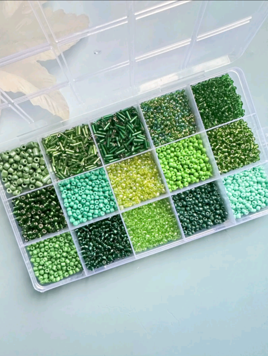 Green seed bead variety kit in clear plastic organizer box