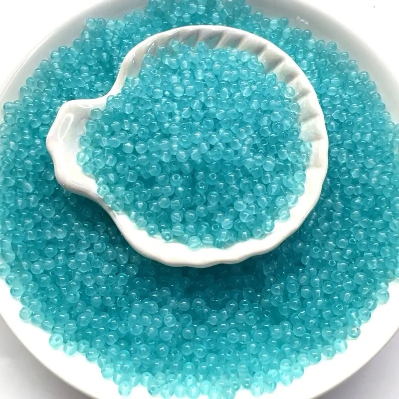 Turquoise seed beads in a shell dish