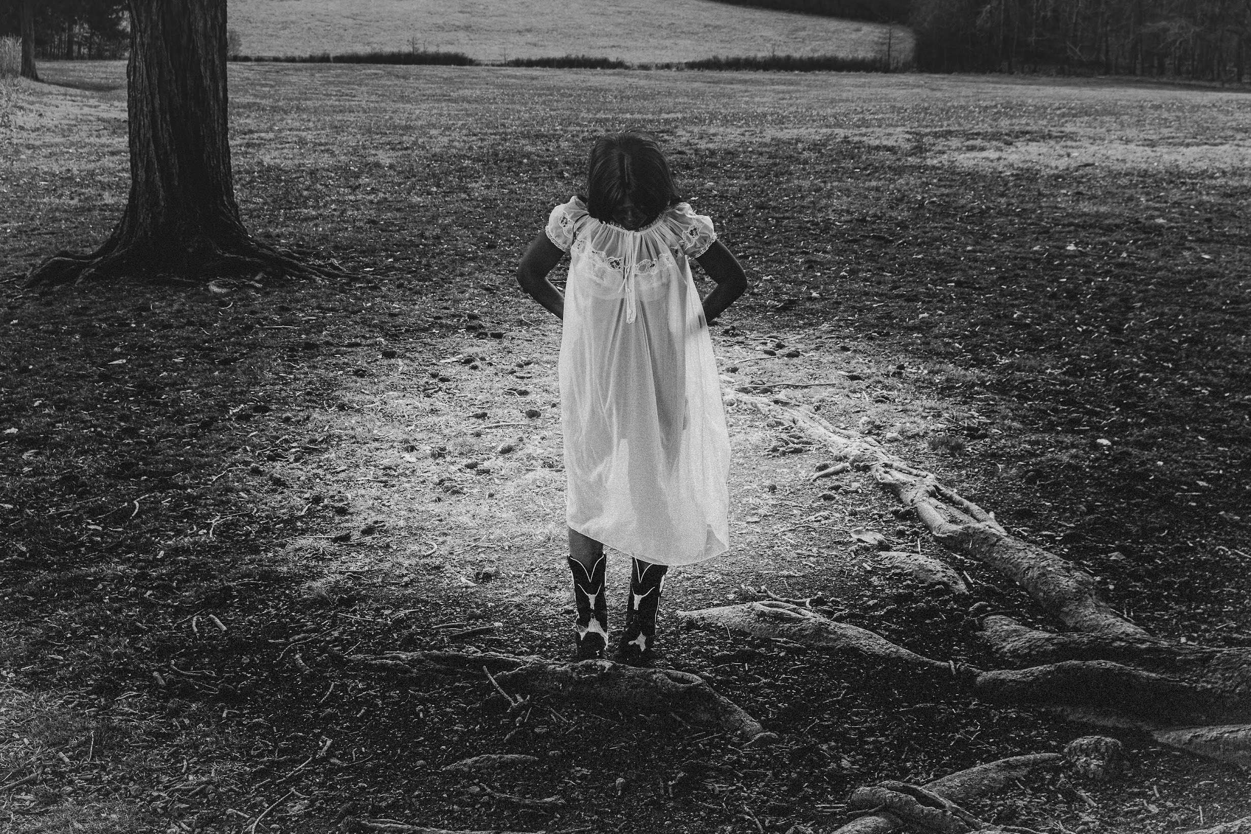 Noa Omane in white dress in a field — black and white