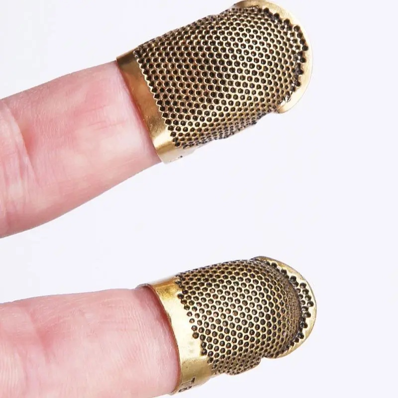 Bronze finger thimbles on fingertips
