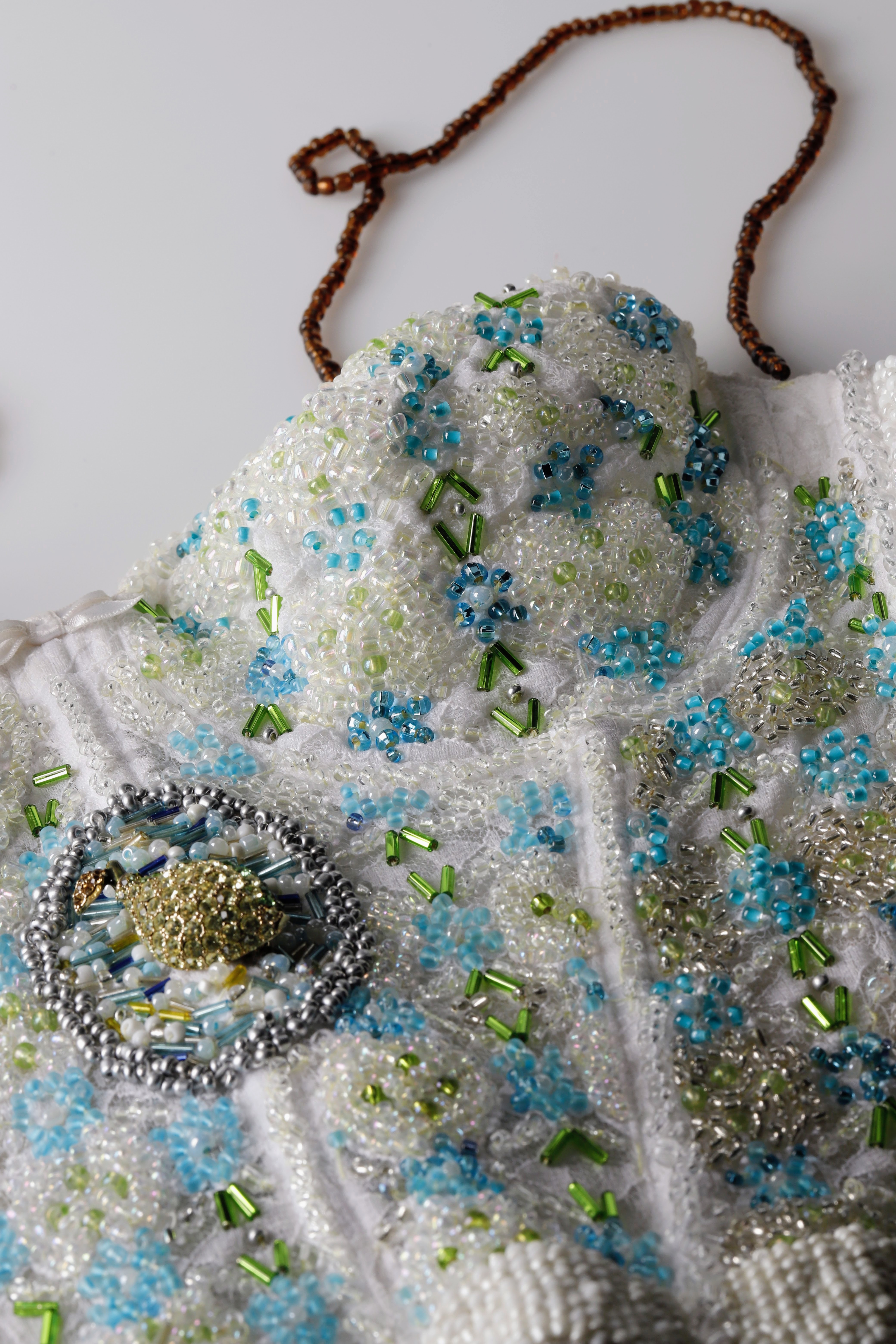 Hand-beaded white corset — blue, green and silver beadwork